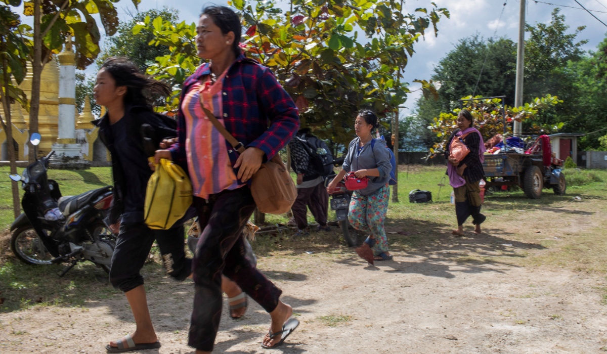 Civilians trapped amid airstrikes run to safety during a battle to take over Loikaw in Kayah State, Myanmar. (REUTERS)