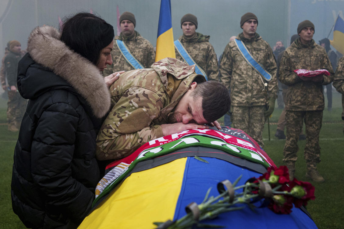 A Ukrainian serviceman bids farewell to his comrade Pavlo Vedybida aka "Obolonchik" at the Obolon Stadium in Kyiv, Ukraine, Saturday, Nov. 30, 2024. (AP)