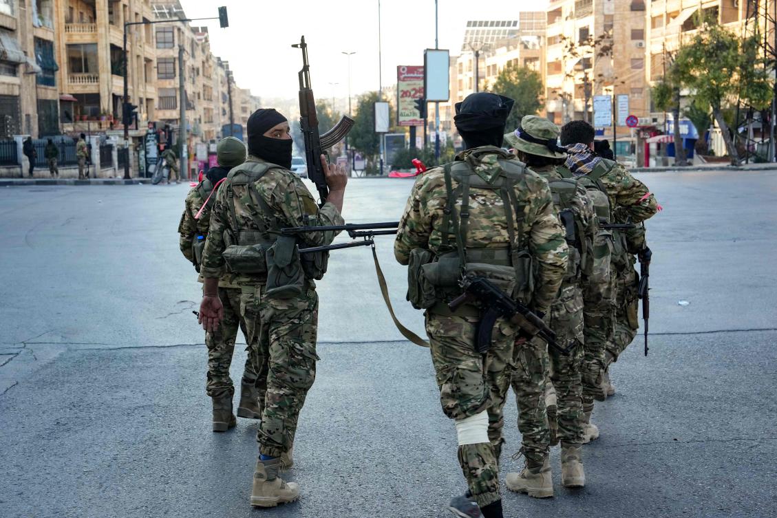 Militants patrol in central Aleppo on November 30, 2024. Jihadists and their Turkish-backed allies breached Syria’s second city of Aleppo on November 29, as they pressed a lightning offensive against forces of the Iranian- and Russian-backed government. (AFP)