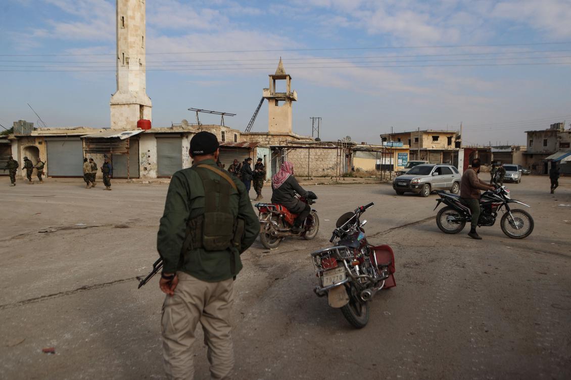 Fighters gather in the area of Zarbah on November 29, 2024, as Hayat Tahrir al-Sham (HTS) jihadists and allied groups continue their offensive in Syria's northern Aleppo province against government forces. (AFP)