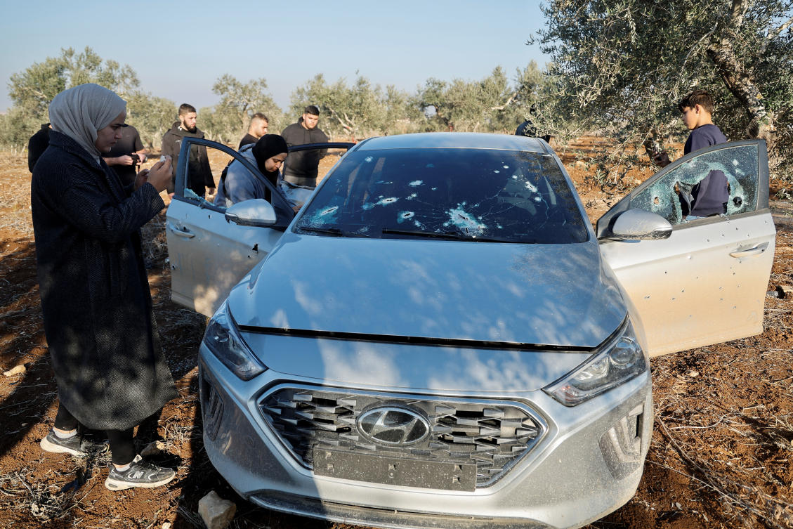 People inspect a car damaged during an Israeli raid, in Sir, near Jenin in the Israeli-occupied West Bank, December 1, 2024. (Reuters)