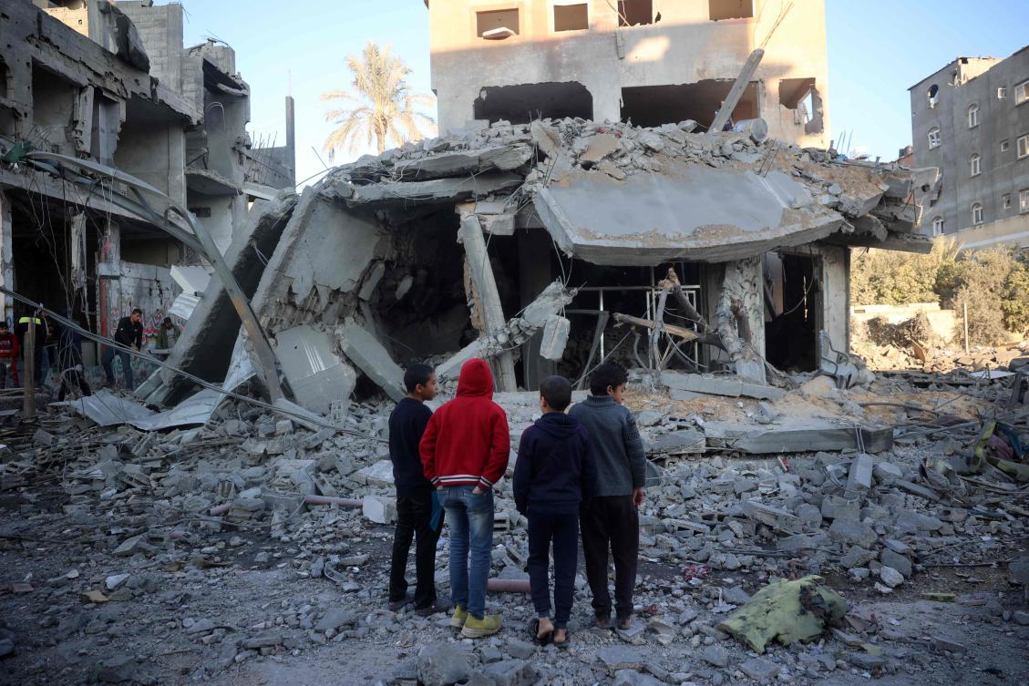 Palestinian children stare at a building destroyed in an Israeli airstrike in Nuseirat in the central Gaza Strip on December 1, 2024. (AFP)