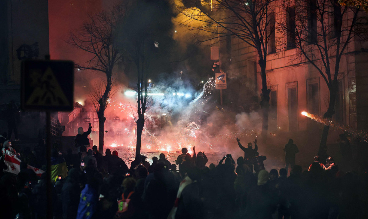 Protesters clash with police outside Georgia parliament during a demonstration against the government's decision to delay European Union membership talks amid a post-election crisis, in Tbilisi, early on December 1, 2024. (AFP)