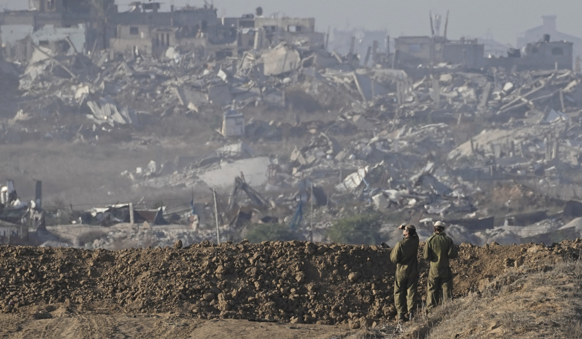 Israeli soldiers look at a destroyed part of Gaza City from their position at the Israel-Gaza border, as seen from southern Israel, Sunday Dec. 1, 2024. (AP)