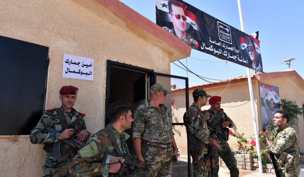 Members of the Syrian security forces gather at the border-crossing between Albu Kamal in Syria and Al-Qaim in Iraq, on the Syrian side in the eastern region of Deir Ezzor, on September 30, 2019. (AFP)
