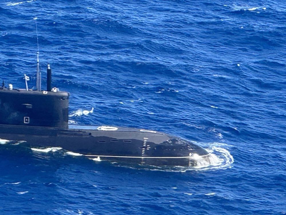 Above, an aerial shot of a Russian Kilo-class submarine UFA 490, spotted 80 nautical miles from Mindoro island in the disputed South China Sea. (Armed Forces of the Philippines via AFP)