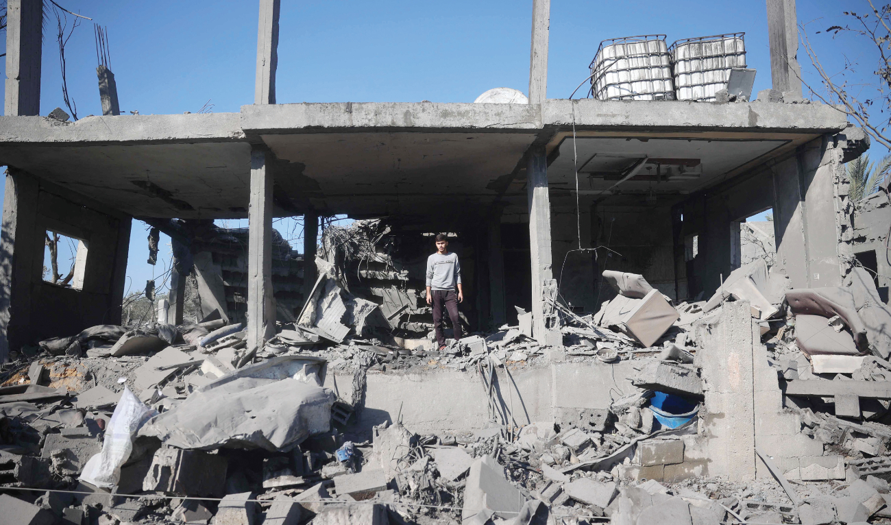 A Palestinian boy inspects the destruction at the site of an Israeli strike that targeted a house in the Bureij refugee camp in the central Gaza Strip on Monday. (AFP)