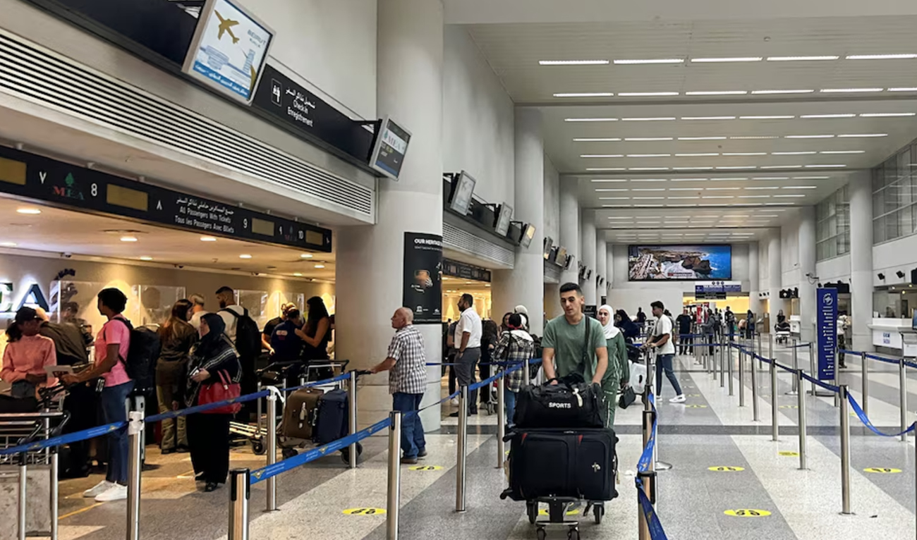 Passengers wait near check-in desks inside Beirut-Rafic Al Hariri International Airport in Beirut on October 17, 2024. (REUTERS/File)