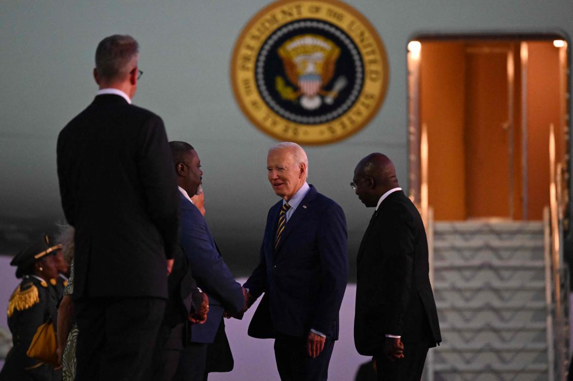 US President Joe Biden, center, greets dignitaries next to Angola Foreign Affairs Minister Tete Antonio, right, upon his arrival at the Quatro de Fevereiro Luanda International Airport in Luanda on Dec. 2, 2024. (AFP)