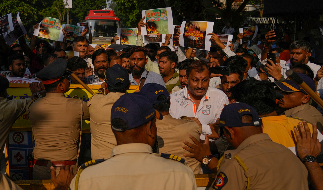 Members of Vishwa Hindu Parishad (VHP) shout slogans as they are stopped by police during a protest outside the Bangladesh High Commission in Mumbai on December 2, 2024. (AP)