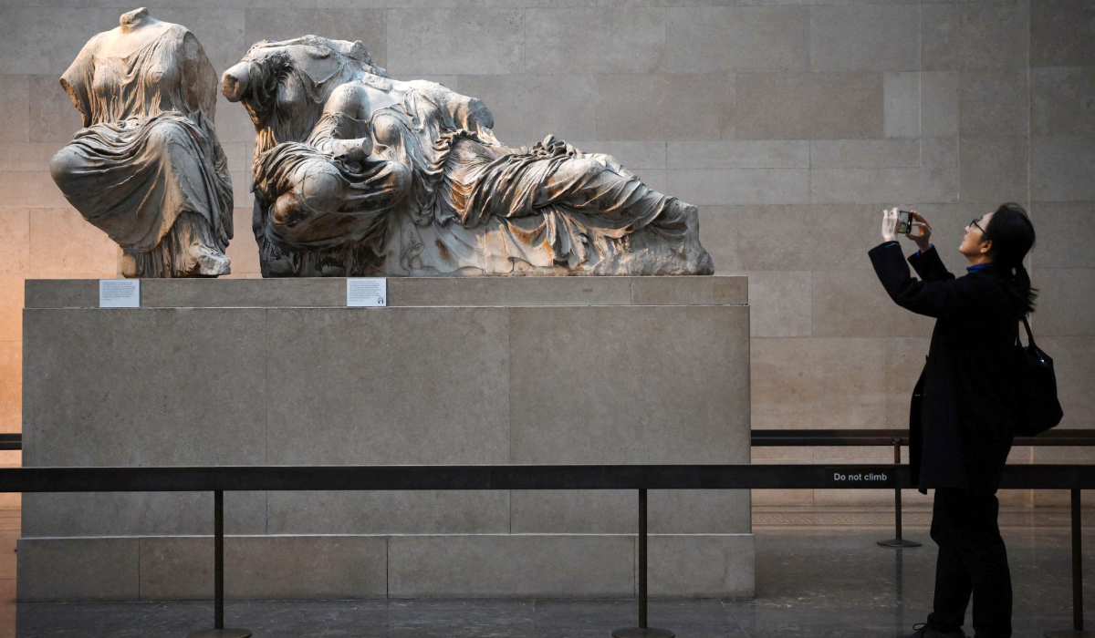 Visitors view the Parthenon Marbles, also known as the Elgin Marbles, at the British Museum in London on January 9, 2023. (AFP)