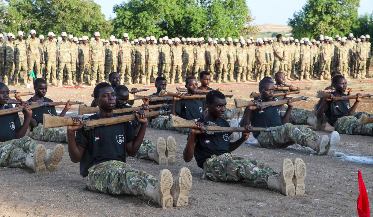 New members of Sudan's armed forces display their skills during a graduation ceremony in the eastern city of Gedaref on November 5, 2024. (AFP)