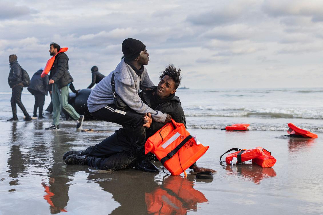 A Sudanese migrant reacts on the shore after leaving a smuggler's boat, which was punctured by French police officers to prevent migrants from embarking in an attempt to cross the English Channel, on the beach of Gravelines, near Dunkirk, northern France on April 26, 2024. (File/AFP)