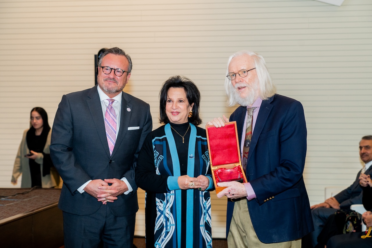 CERN physicist John Ellis (right) receives an award from Bahrain's Shaikha Mai bint Mohammed Al-Khalifa (center) and Bradley J Cook, American University of Bahrain President, during an event in Manama on Tuesday Dec. 3, 2024. (AN/Abdulrahman bin Shalhoub)
