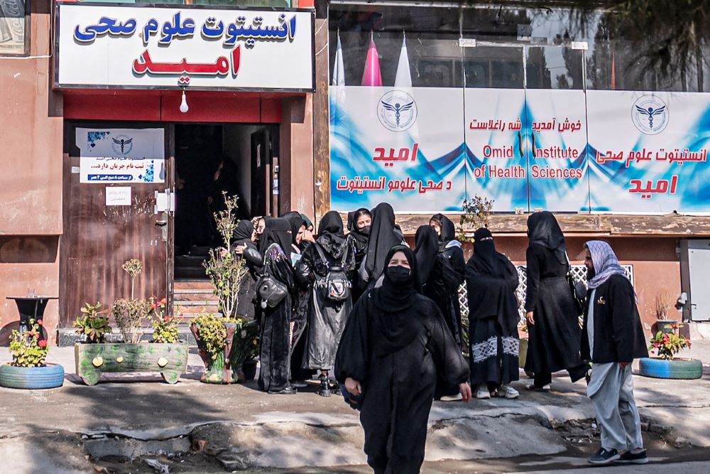 Women gather in front of the Omid Institute of Health Sciences in Kabul, after they were barred from attending classes on Dec. 3, 2024. (AFP)