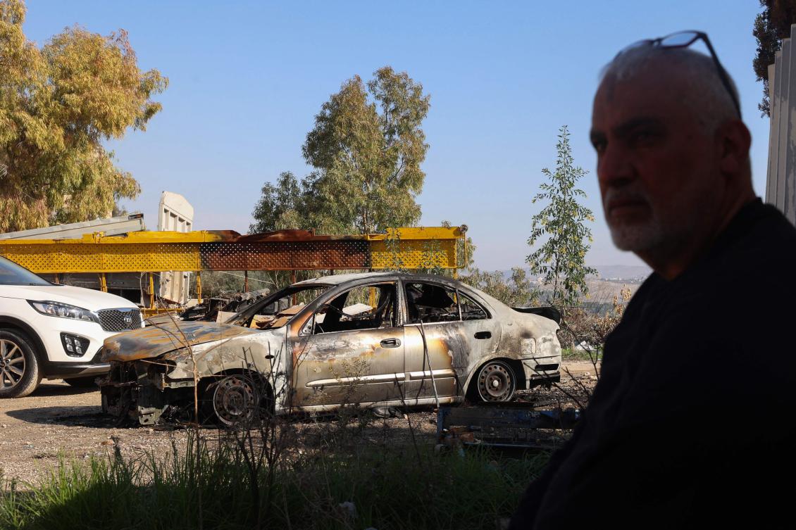 A Palestinian man inspects a damaged car in front of his house following a reported attack earlier by Israeli settlers in Huwara town, south of Nablus, in the occupied West Bank, Dec. 4, 2024. (AFP)