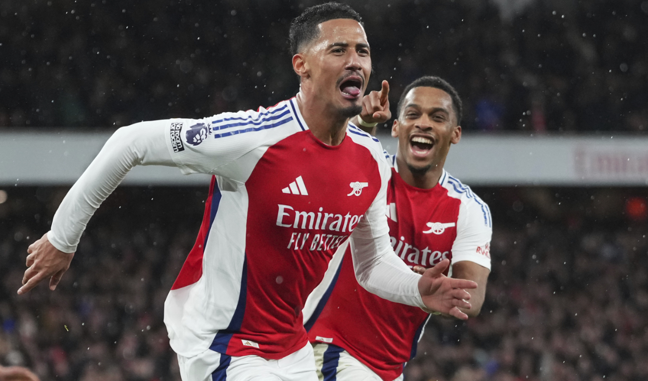 Arsenal's William Saliba, left, celebrates after scoring his side's second goal during the English Premier League soccer match between Arsenal and Manchester United at Emirates stadium in London, Wednesday, Dec. 4, 2024. (AP)