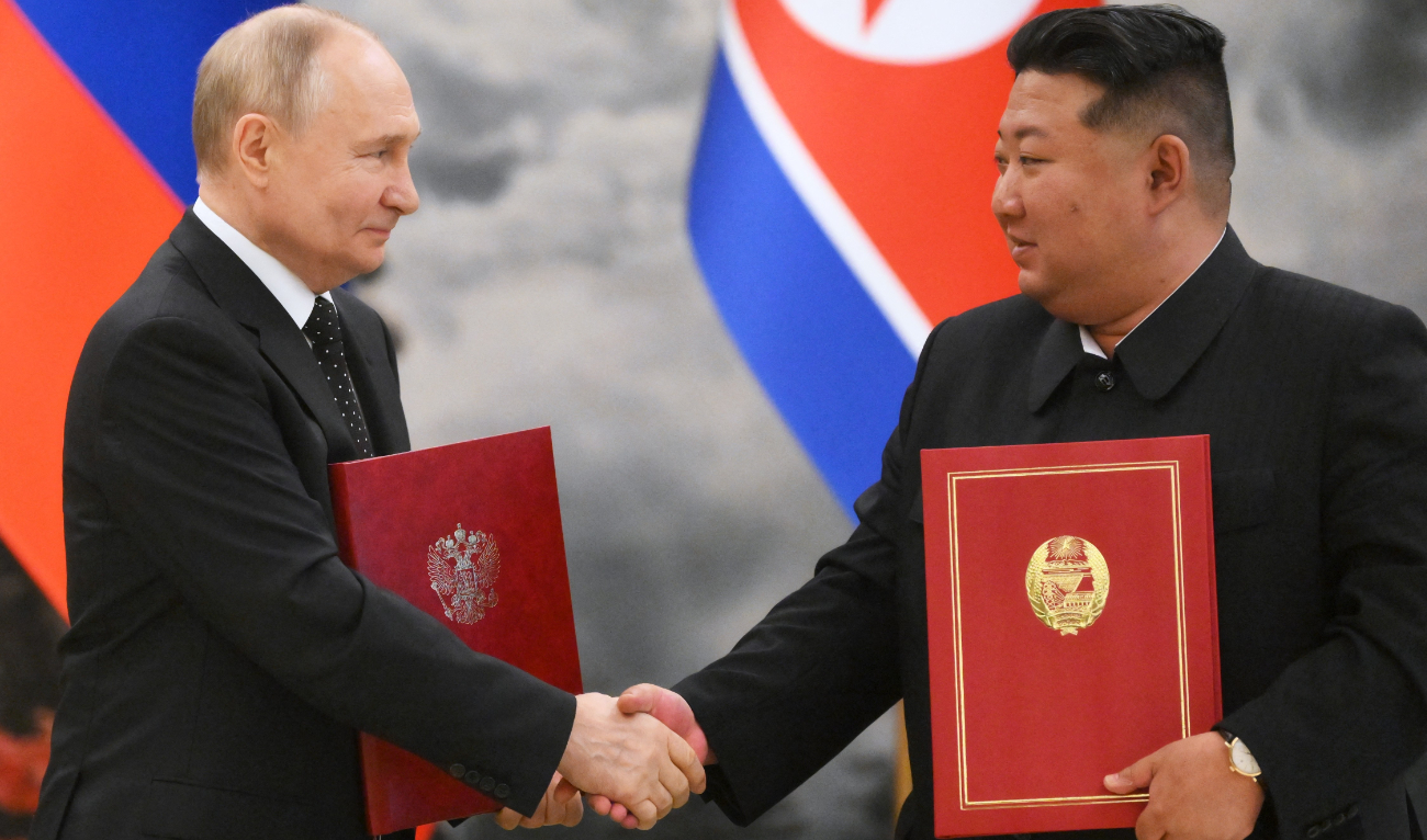 In this pool photograph distributed by the Russian state agency Sputnik, Russian President Vladimir Putin (L) shakes hands with North Korea's leader Kim Jong Un (R) after a signing ceremony following their bilateral talks at Kumsusan state residence in Pyongyang, on June 19, 2024. (AFP/File)