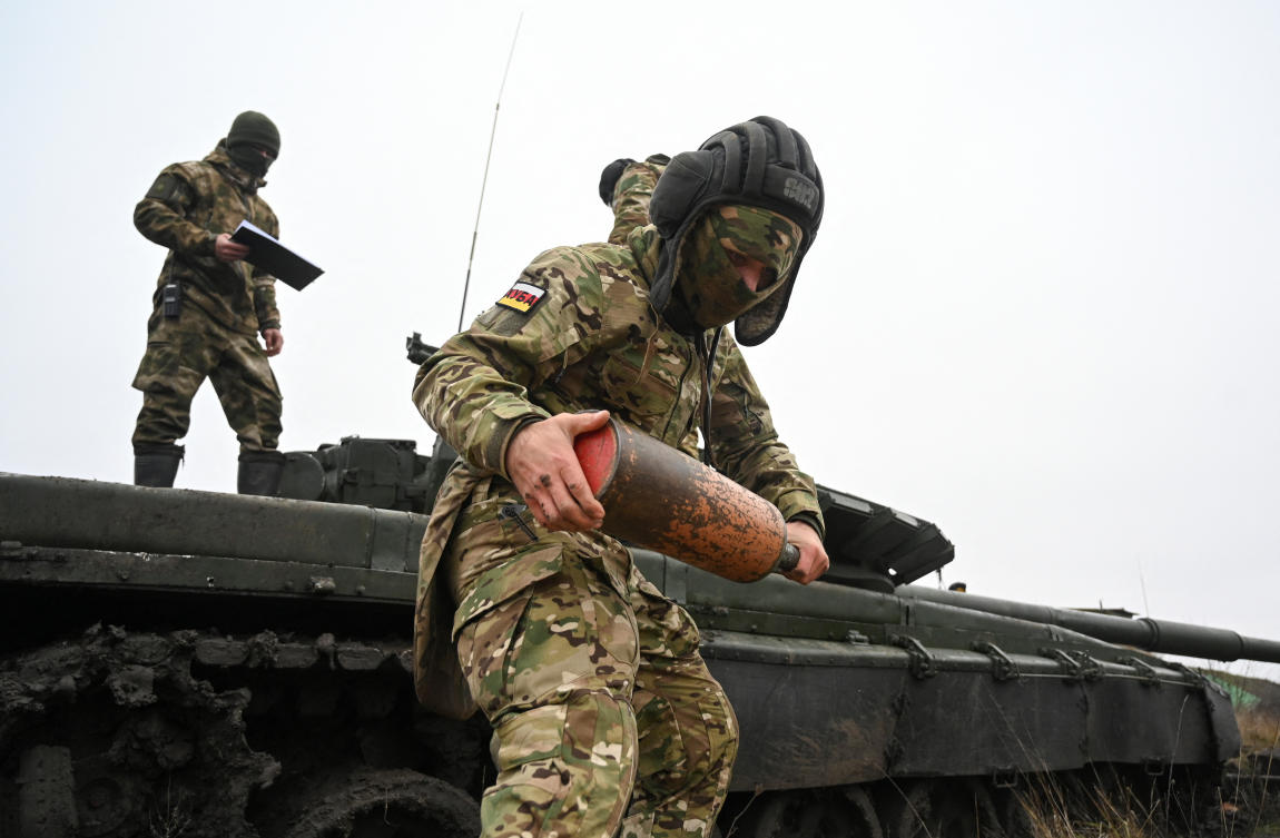 A Russian contract soldier listens to instructions of an officer while training near a T-72 tank during military drills in the southern Krasnodar region, Russia. (Reuters)