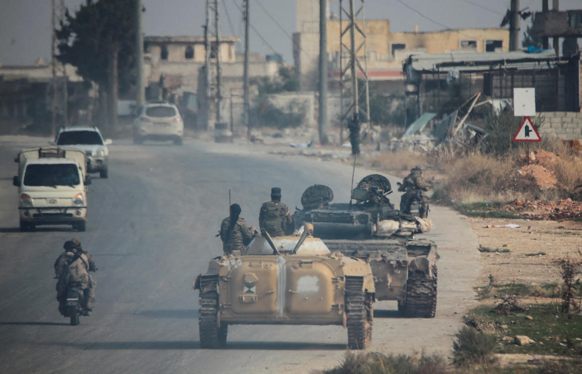 Militants led by the Islamist militant group Hayat Tahrir al-Sham drive along a street in al-Rashideen, Aleppo province, Syria November 29, 2024. (Reuters)