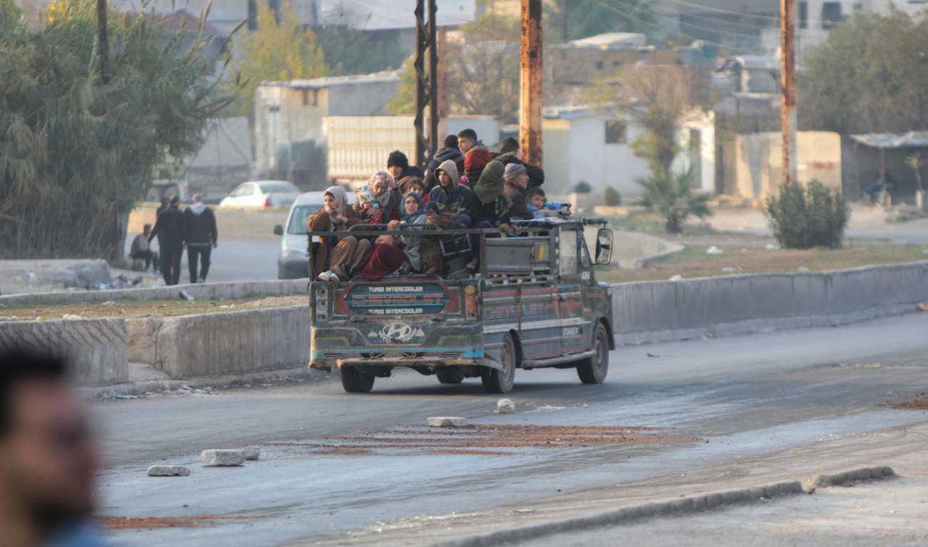Displaced Syrians drive through Khan Shaykhun town as they evacuate northward to flee confrontation areas in the Hama governorate on December 5, 2024. (AFP/File)