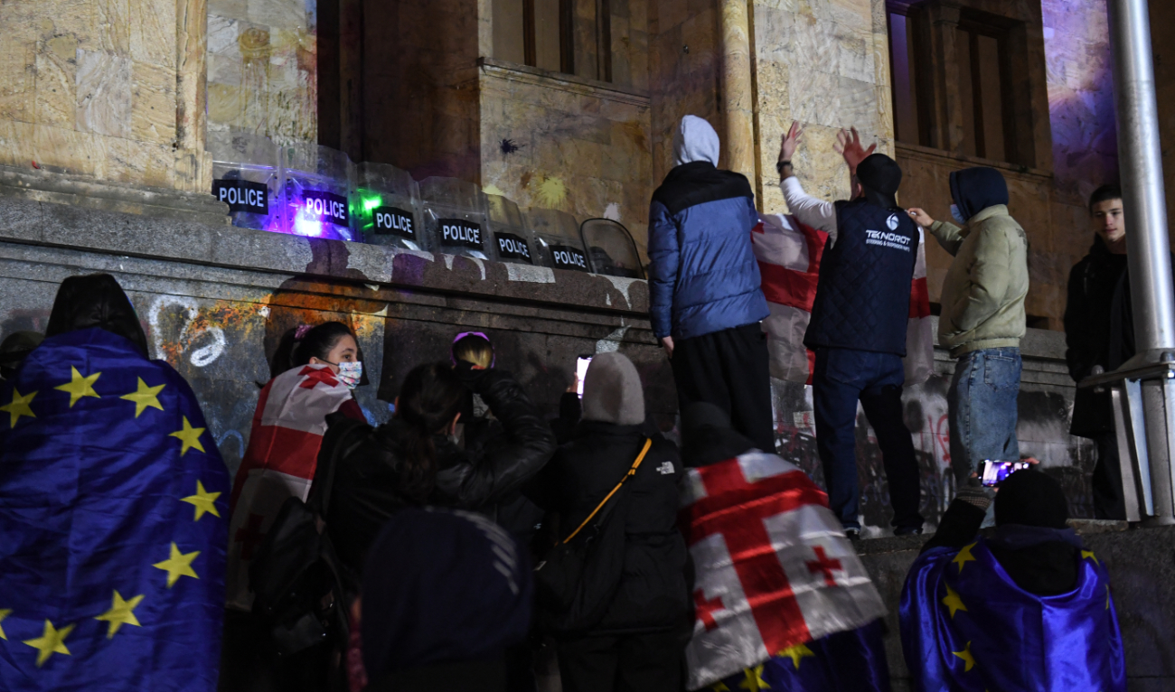 Police forces secure the parliament building as anti-government protesters rally for an eighth consecutive day of mass demonstrations against the government's postponement of European Union accession talks until 2028, in central Tbilisi early on December 6, 2024. (AFP)