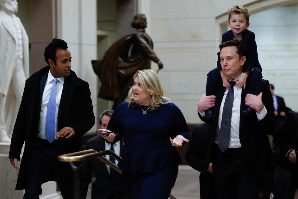Tesla CEO Elon Musk (R), Co-Chair of the newly announced Department of Government Efficiency (DOGE) carries his son on his shoulders at the U.S. Capitol following a meeting with businessman Vivek Ramaswamy (L), Co-Chair of the newly announced Department of Government Efficiency, Rep. Kat Cammack (C), and other members of the U.S. Congress on December 05, 2024 in Washington, DC. (Getty Images/AFP)