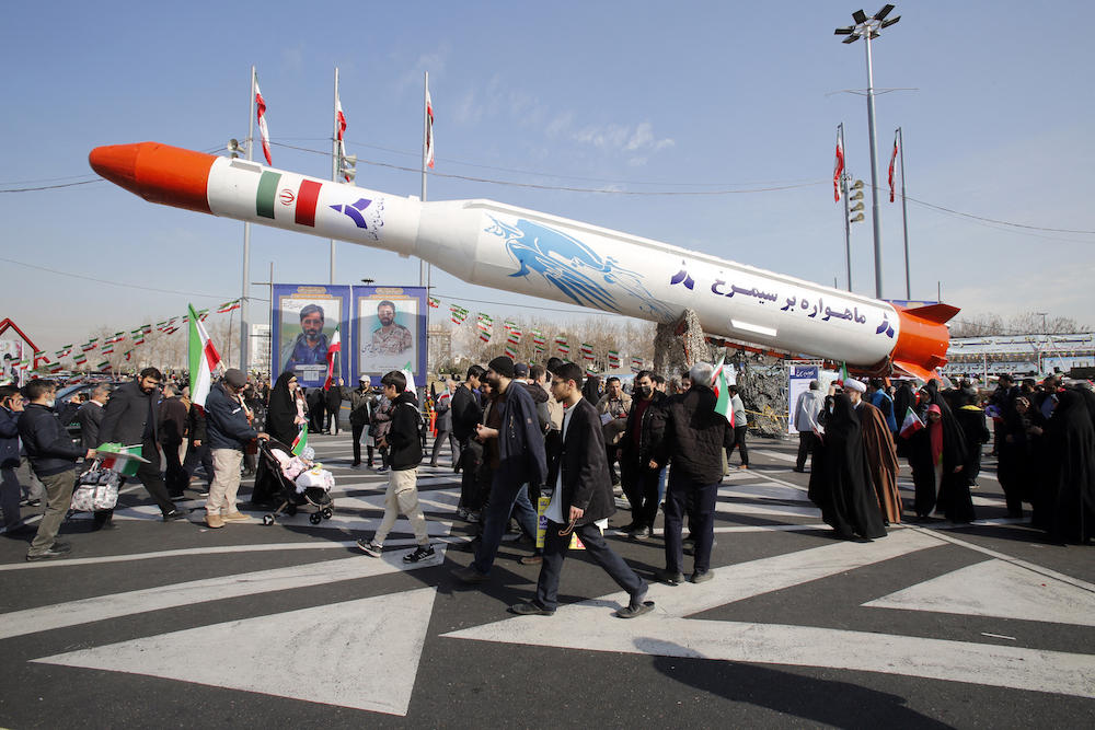 Above, Iran’s two-stage Simorgh satellite carrier is displayed in Tehran as people gather to mark the 45th anniversary of the Islamic revolution on Feb. 11, 2024. (AFP)