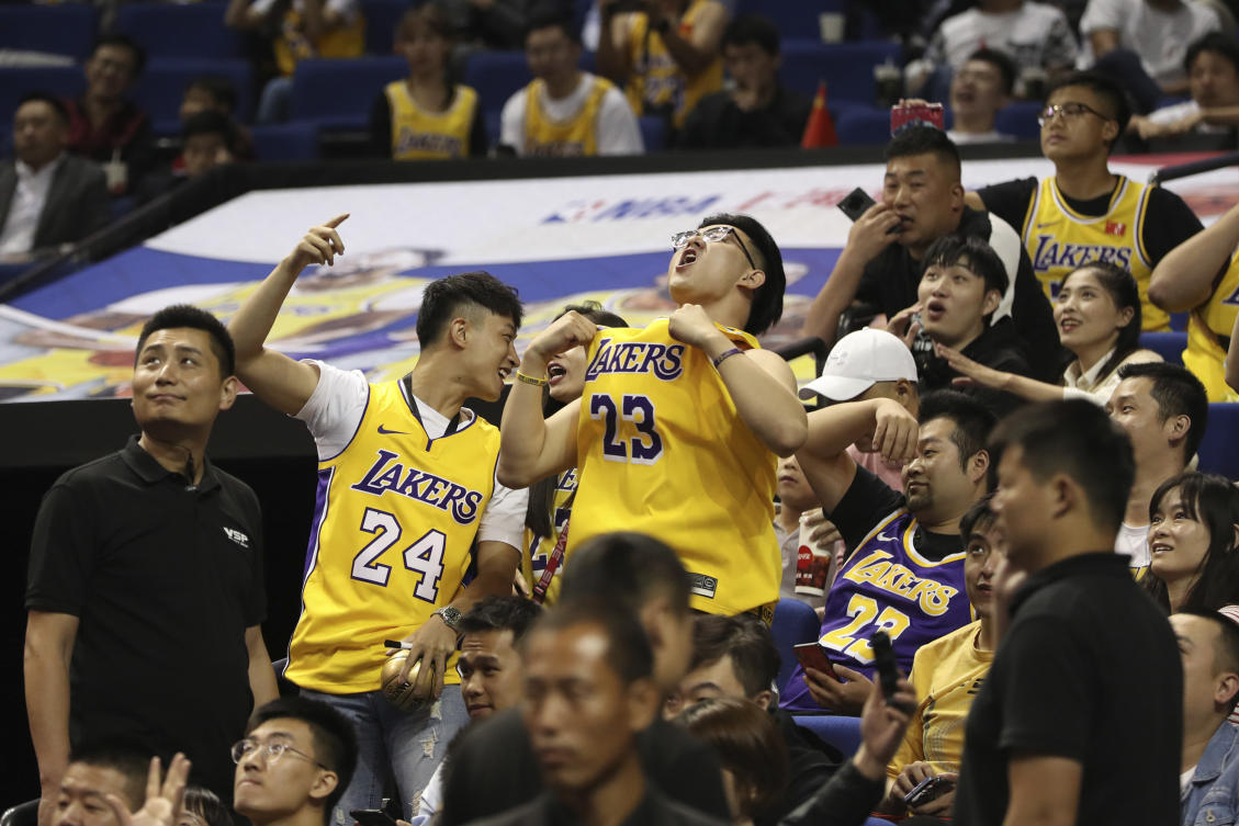Chinese fans react during a preseason NBA basketball game between the Brooklyn Nets and Los Angeles Lakers at the Mercedes Benz Arena in Shanghai on Oct. 10, 2019. (AP)