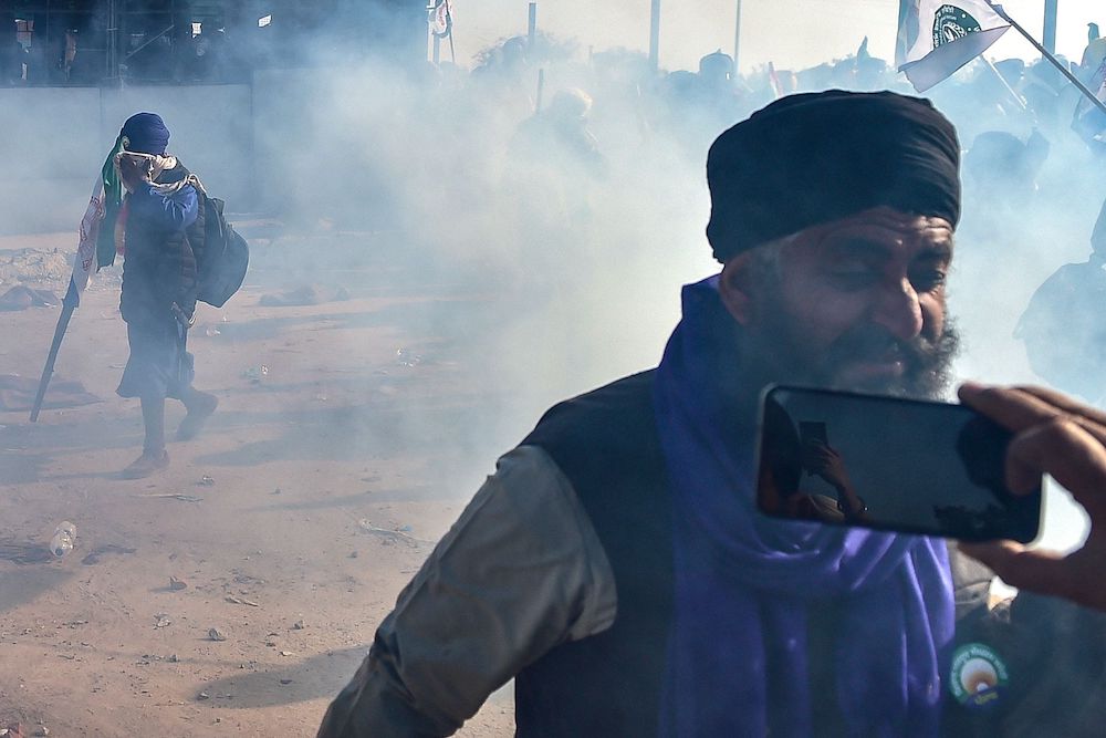 Farmers disperse after police fired tear gas to prevent them from marching towards India’s capital, Delhi, at the Shambhu Border in Punjab on Dec. 6, 2024. (AFP)