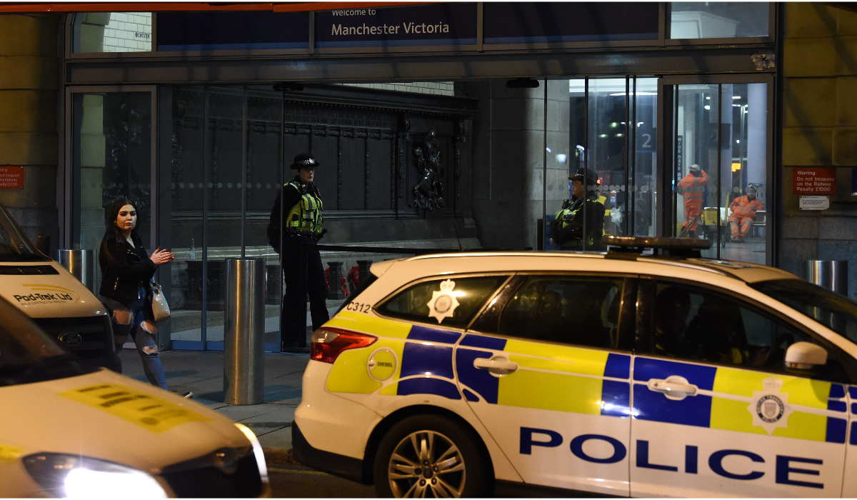 Police officers stand near a cordon at Manchester Victoria Station, in Manchester. (AFP file photo)