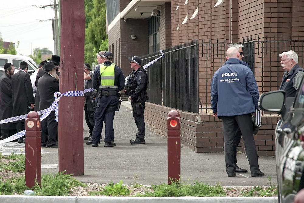 Police officers investigate near the scene of a fire at the Adass Israel Synagogue in Melbourne on Dec. 6, 2024. (AFP)