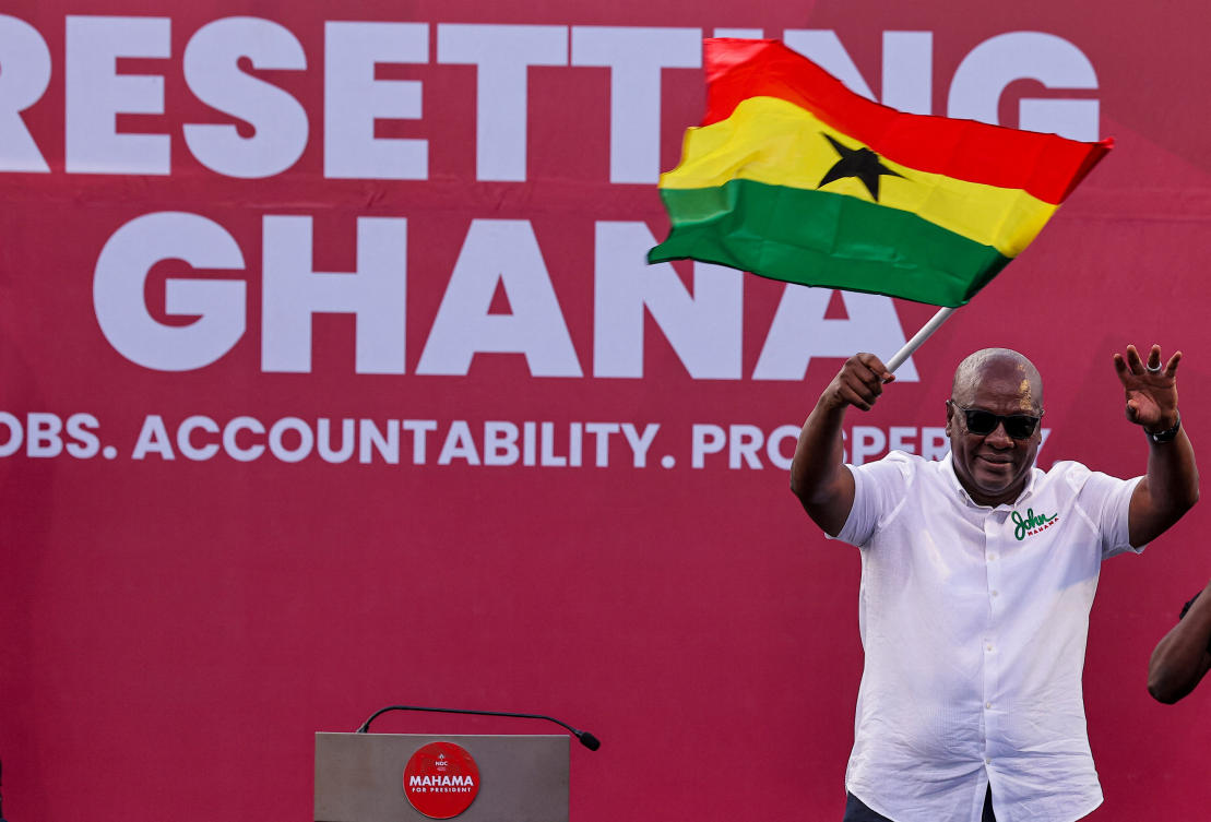 National Democratic Congress (NDC) presidential candidate and former Ghanaian President John Dramani Mahama holds a national flag as he waves to supporters during his final election campaign rally in Accra, Ghana December 5, 2024. (REUTERS)