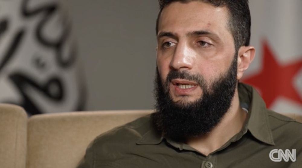 Abu Mohammad Al-Jolani spoke to CNN’s Jomana Karadsheh about the ongoing crisis in Syria. (Screenshot/CNN)