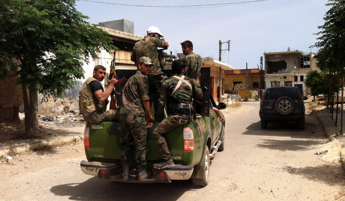 A picture taken on June 8, 2013 shows Syrian army soldiers patroling a street in the village of Buweida, north of Qusayr, in Syria's central Homs province. (AFP)