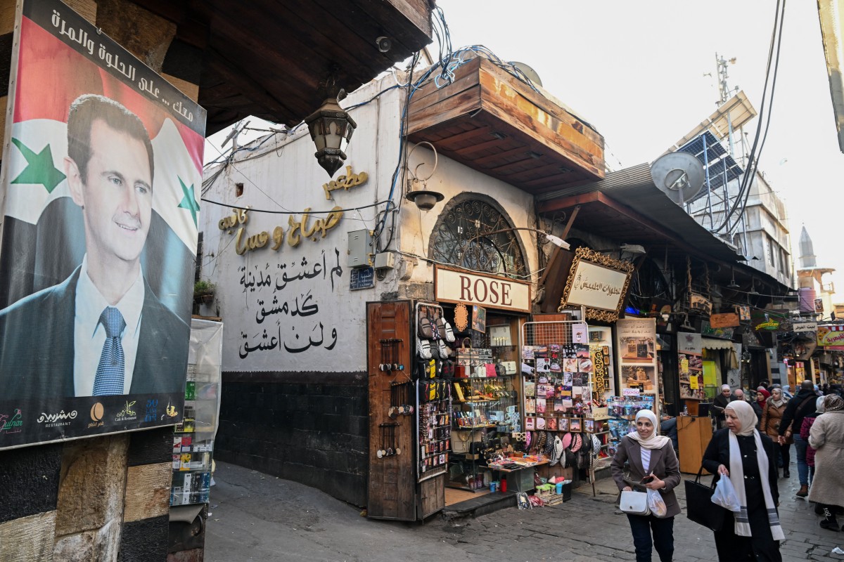 A portrait of Syria's President Bashar al-Assad is displayed in the old city of Syria's capital Damascus on December 6, 2024. Rebel forces pressing a lightning offensive in Syria aim to overthrow President Bashar al-Assad's rule (AFP)