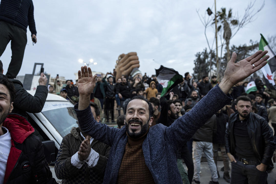 People gather to celebrate the fall of the Syrian government, in Manbij, Syria, Sunday, Dec. 8, 2024. (AP)