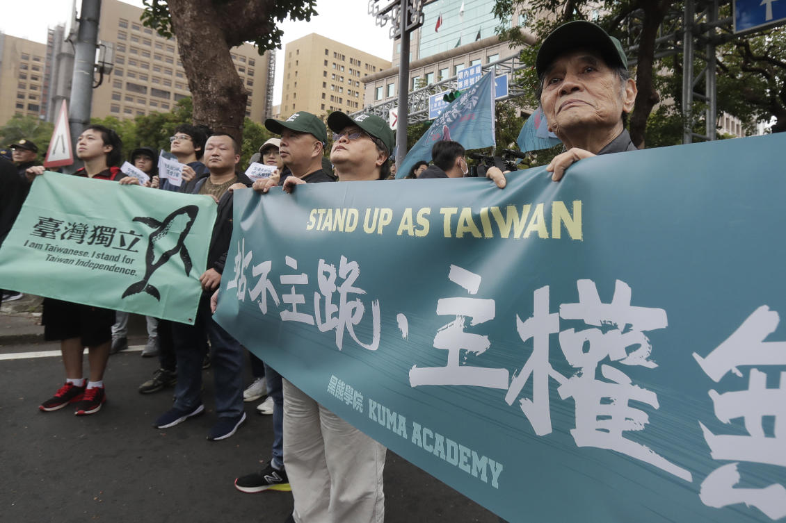 Taiwanese people demonstrate their unwavering commitment to protect their homeland during a march in Taipei on Dec. 8, 2024. A sign, right, reads ‘Stand rather than kneel. Sovereignty.’ (AP)