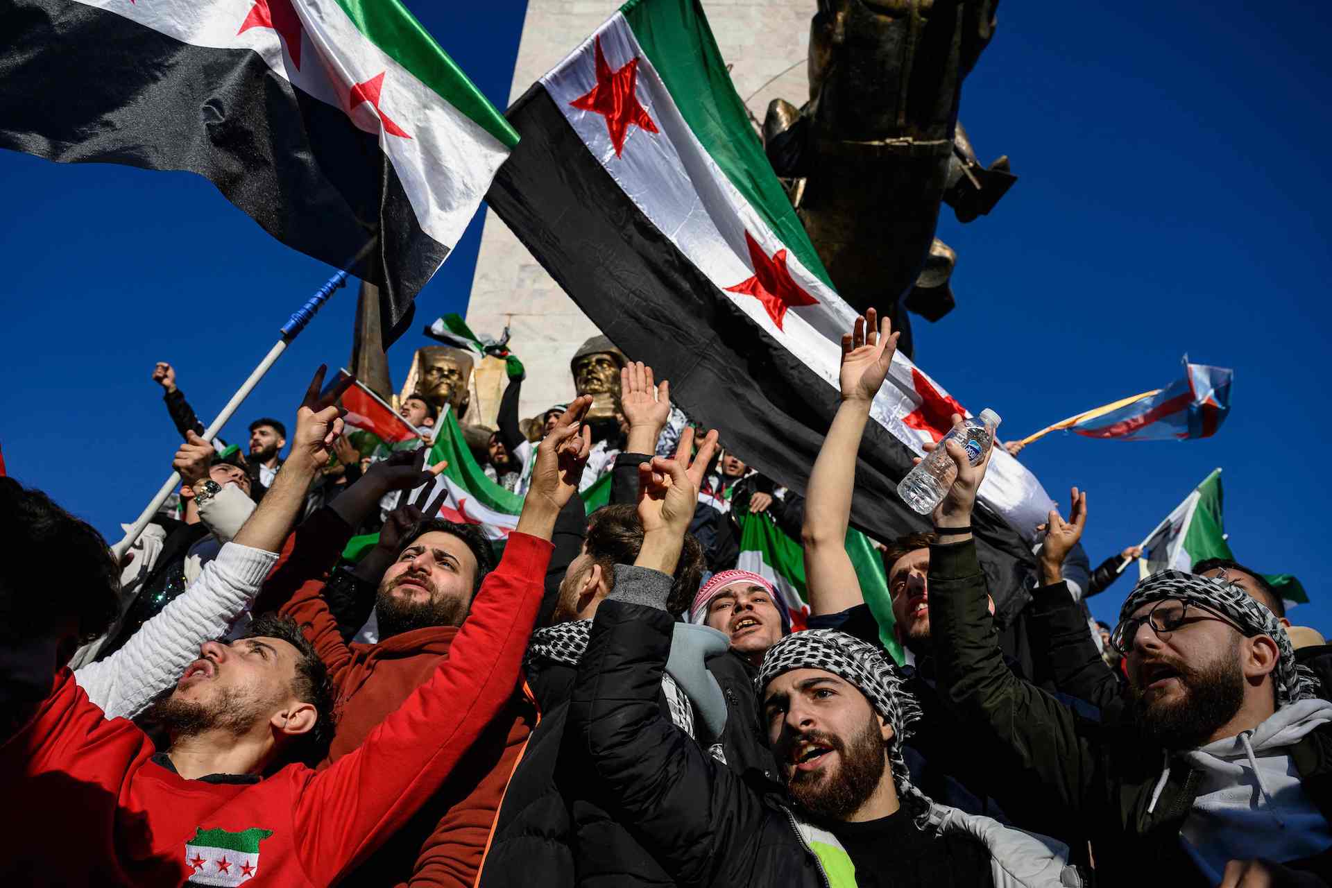 Syrian residents in Turkey wave Syrian opposition flags as they celebrate the fall of long-time ruler Bashar al-Assad after opposition fighters took control of the Syrian capital Damascus overnight, in Istanbul on December 8, 2024. (AFP)