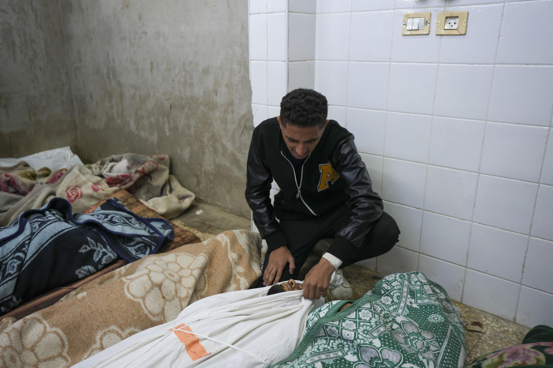 A Palestinian man mourns over the body of a victim following an Israeli bombardment, at the morgue of Al-Aqsa Martyrs hospital in Deir Al-Balah, Gaza Strip, Sunday, Dec. 8, 2024. (AP)