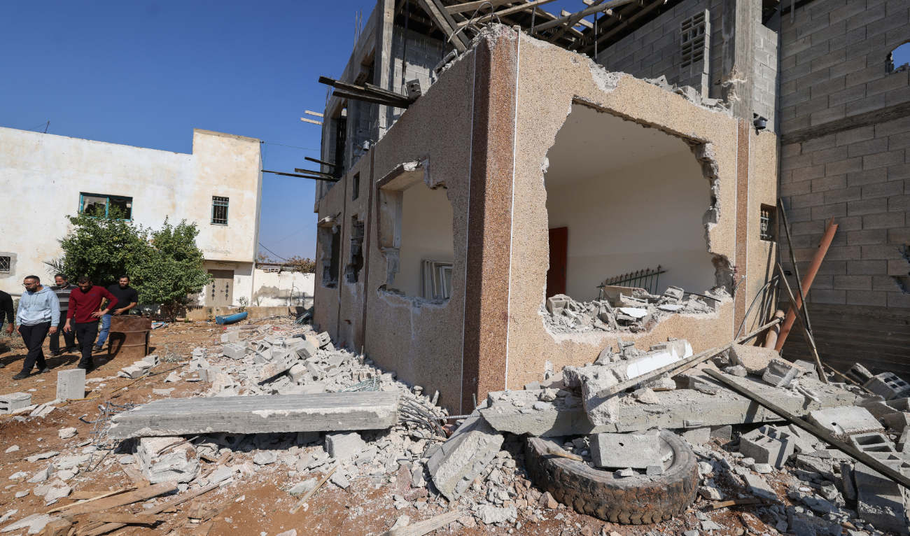 People inspect a damaged building where a Palestinian man was reportedly killed during an Israeli army raid in Tammun village south of Tubas in the occupied West Bank on November 5, 2024. (AFP/File)
