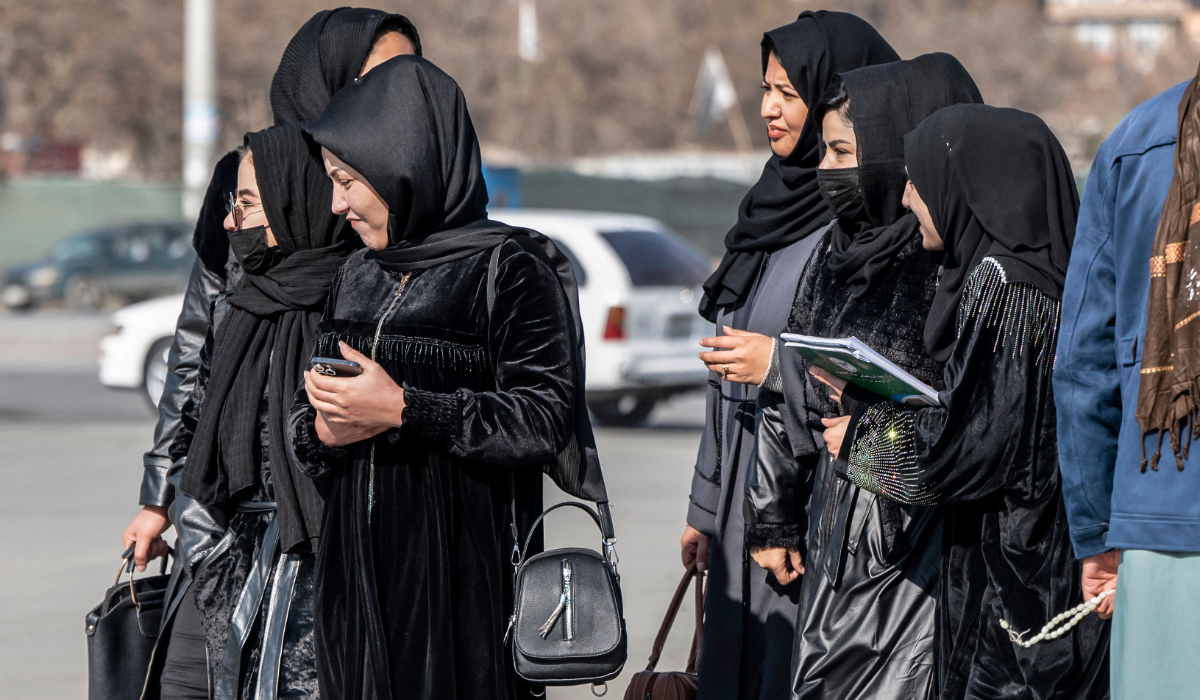 Afghan female students studying health studies walk along a street in Kabul on December 3, 2024. (AFP)