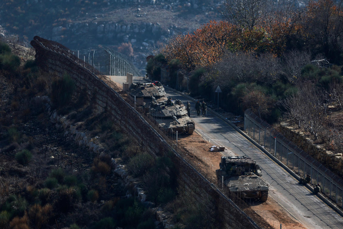 Israeli soldiers stand next to military vehicles as they gather near the ceasefire line between Syria and the Israeli-occupied Golan Heights, Dec. 9, 2024. (Reuters)