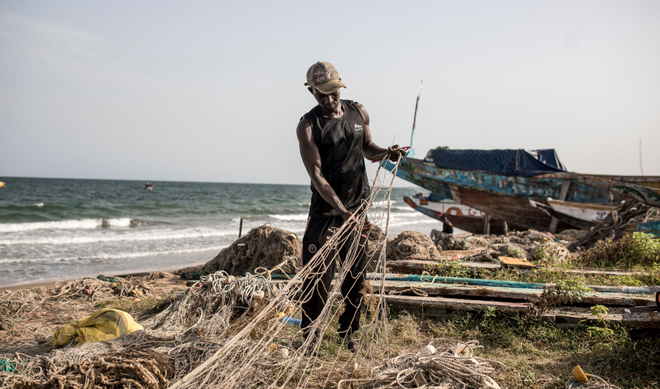 A man prepares a fishing net ahead of going out fishing in Brufut, Ghana Town, in this Oct. 31 file photo. (AFP)