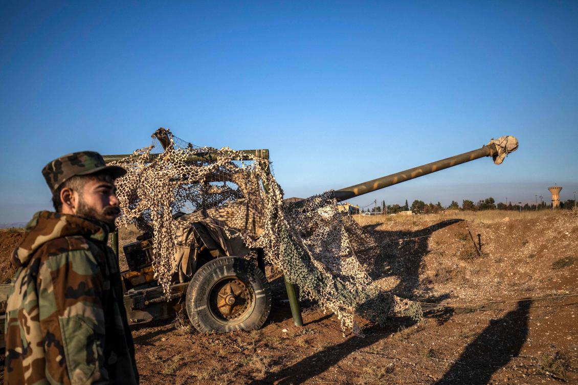 Fighters with the Kurdish-led Syrian Democratic Forces (SDF) inspect damaged and abandoned military vehicles and equipment at the Qamishli international airport, formerly a joint Syrian-russian military base, in northeastern Syria’s city of Qamishli on December 9, 2024.(AFP)
