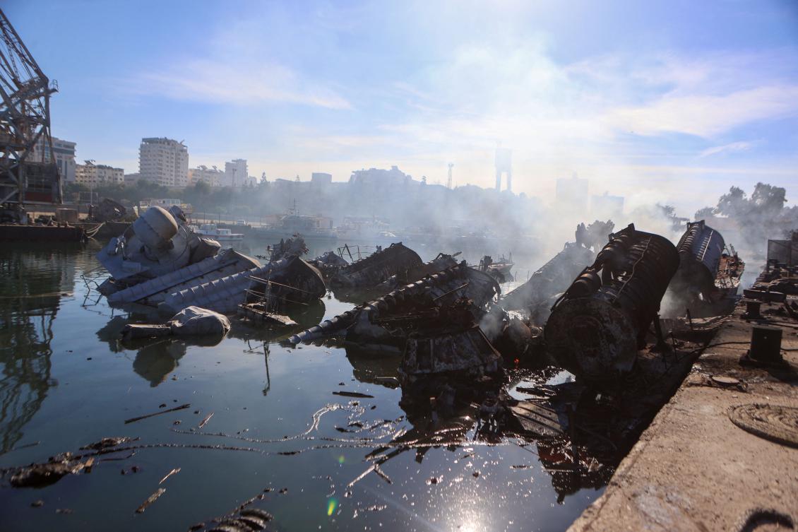 Smoke billows from Syrian naval ships destroyed in an overnight Israeli attack on the port city of Latakia on Dec. 10. (AFP)