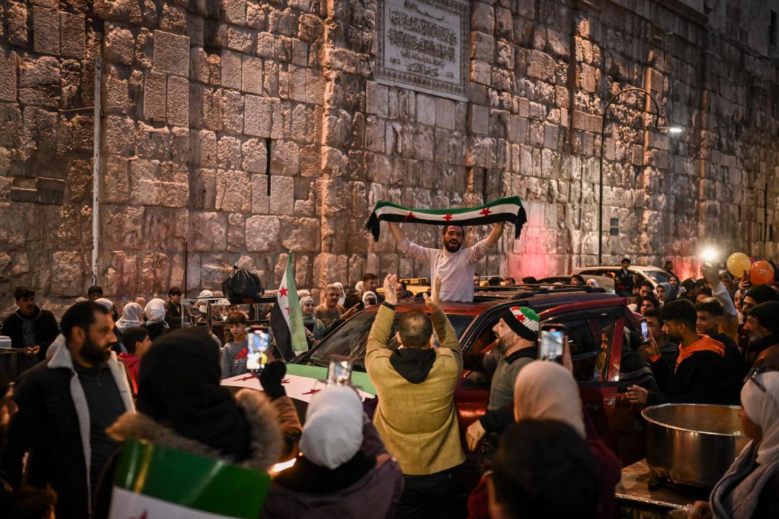 People celebrate outside the Ummayad mosque in the old city of Damascus on Dec. 11, 2024. (AFP)