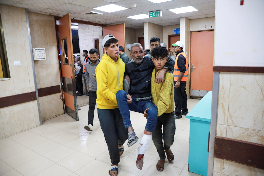 Palestinians carry a wounded man at a hospital Deir Al-Balah in the central Gaza Strip on Dec. 11, 2024. (Reuters)