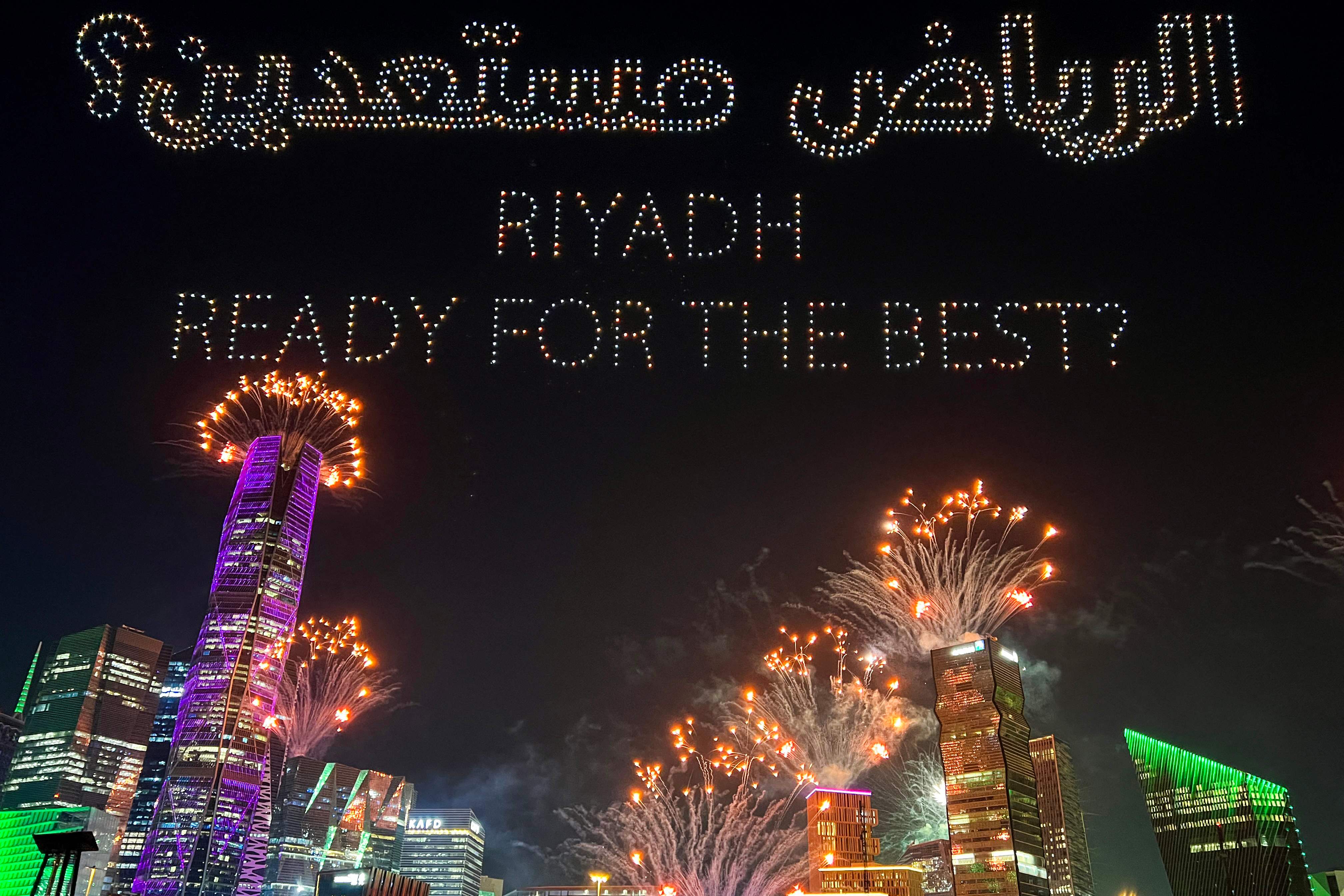 A drone-created light show and fireworks illuminate the sky over Riyadh on December 11, 2024, celebrating Saudi Arabia’s confirmation as the host of the 2034 FIFA World Cup football tournament. Haitham El-Tabei/AFP