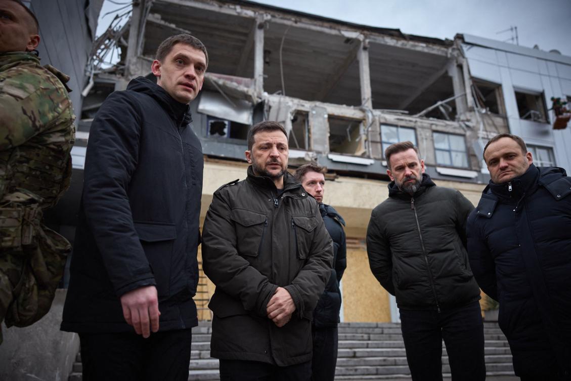 Ukrainian President Volodymyr Zelensky (C) reviewing the aftermath of a missile strike carried out by Russia on December 10, in the city of Zaporizhzhia. (UKRAINIAN PRESIDENTIAL PRESS SERVICE/AFP)